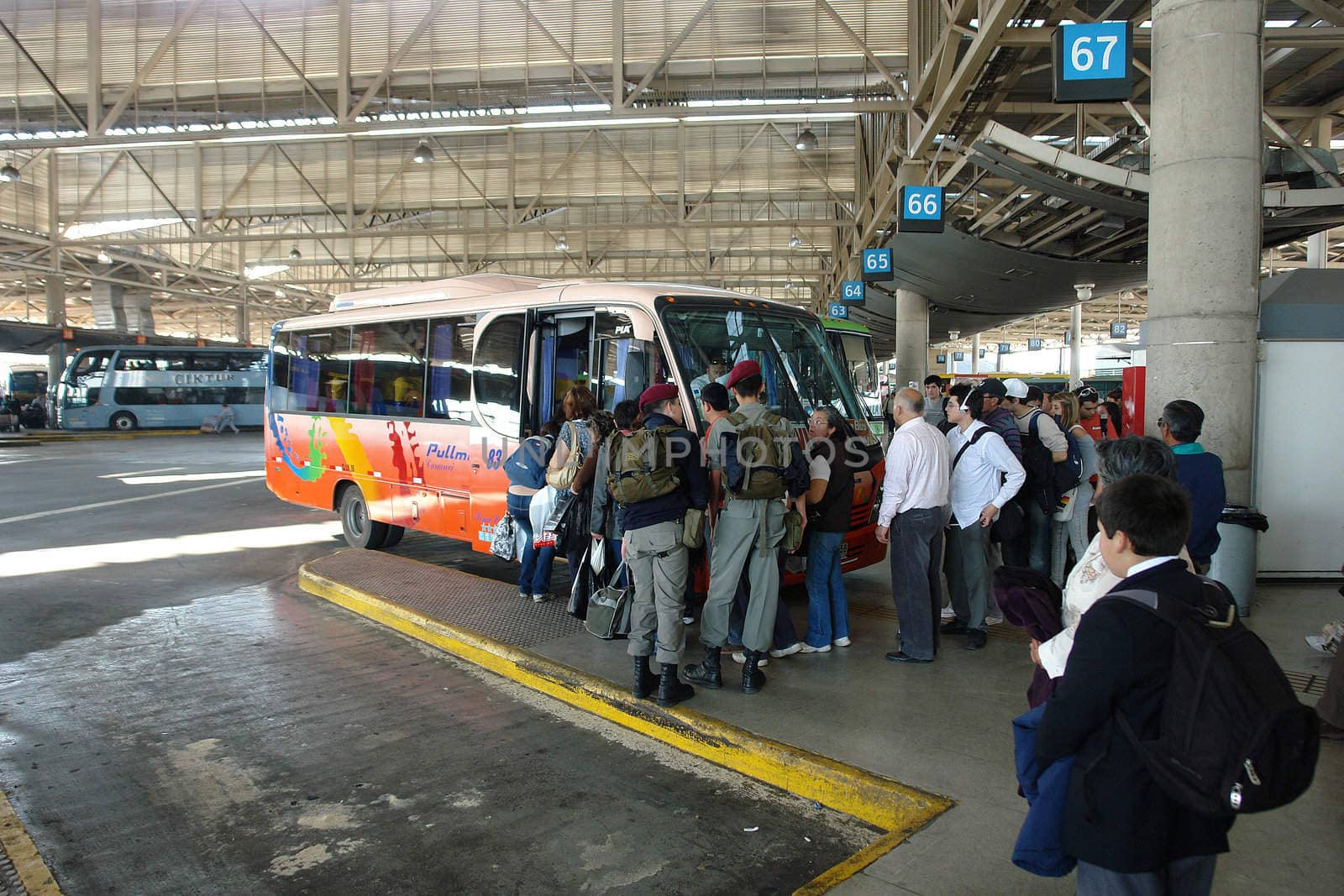 Rural locomotion, passengers at terminal getting on the bus that takes them to them
Different destinations out of here of Santiago city at Chile.