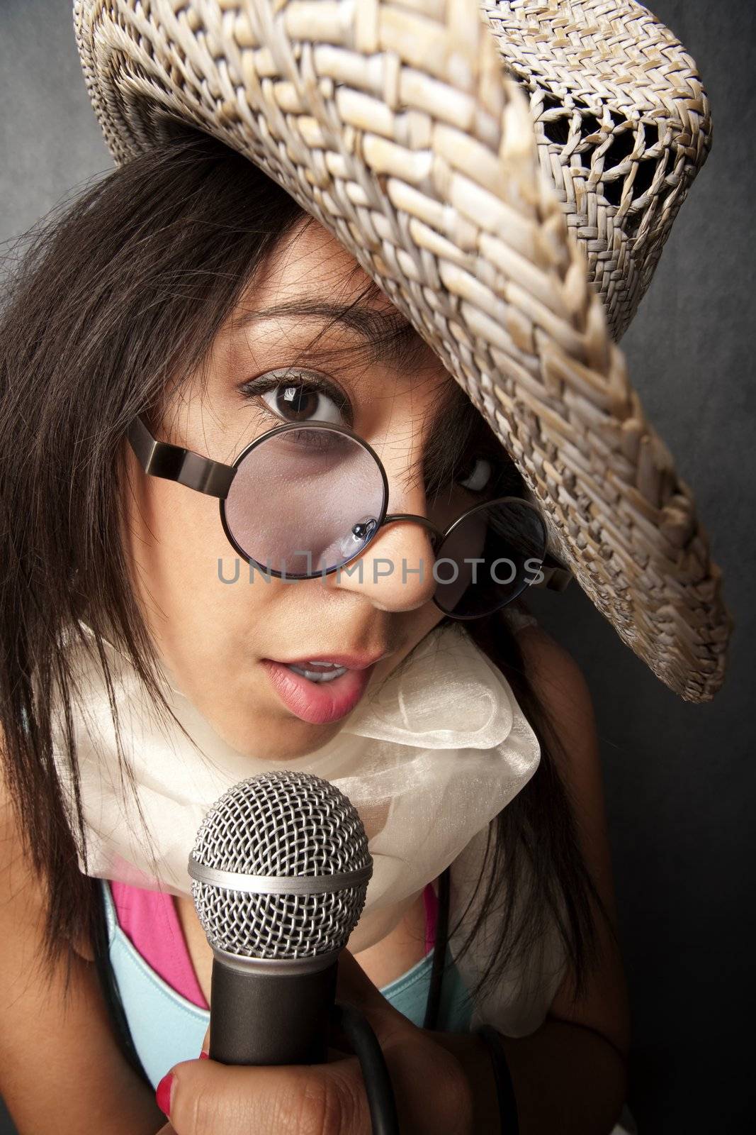 Pretty young singer with a large microphone
