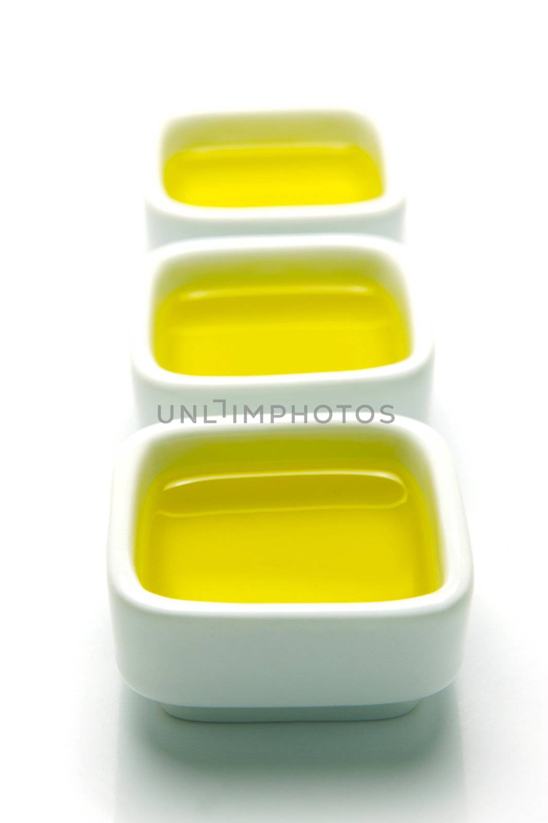 Olive Oil in small serving bowls isolated against a white background
