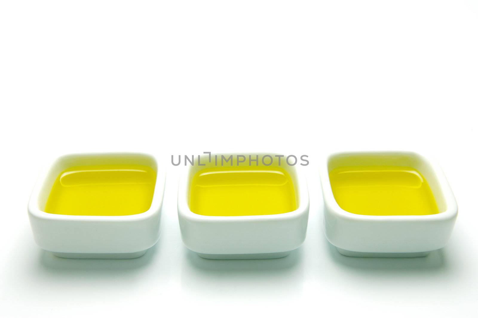 Olive Oil in small serving bowls isolated against a white background