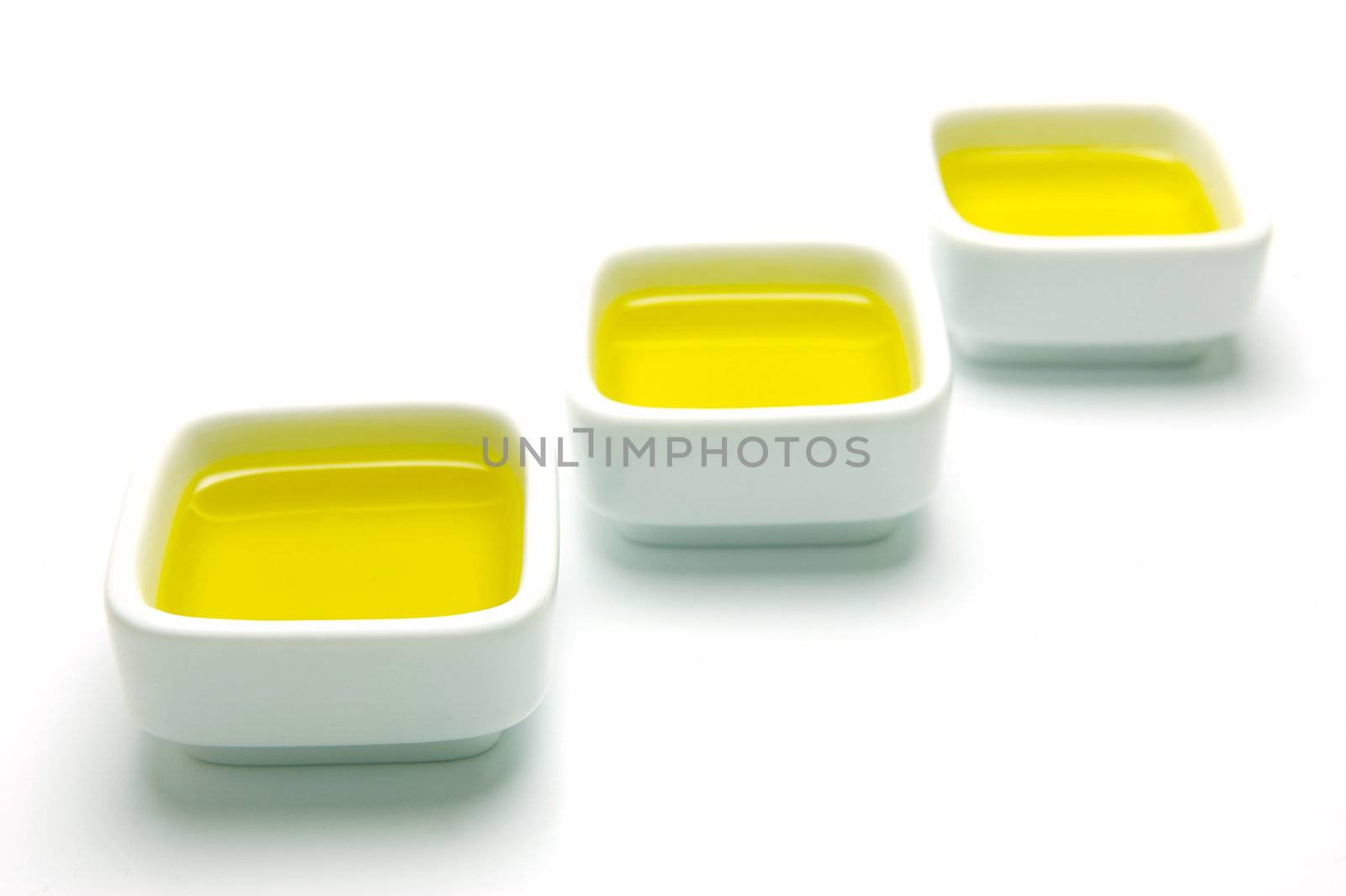 Olive Oil in small serving bowls isolated against a white background