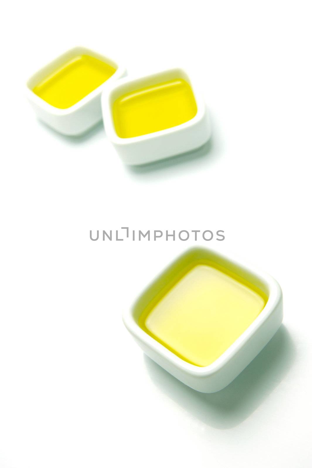Olive Oil in small serving bowls isolated against a white background