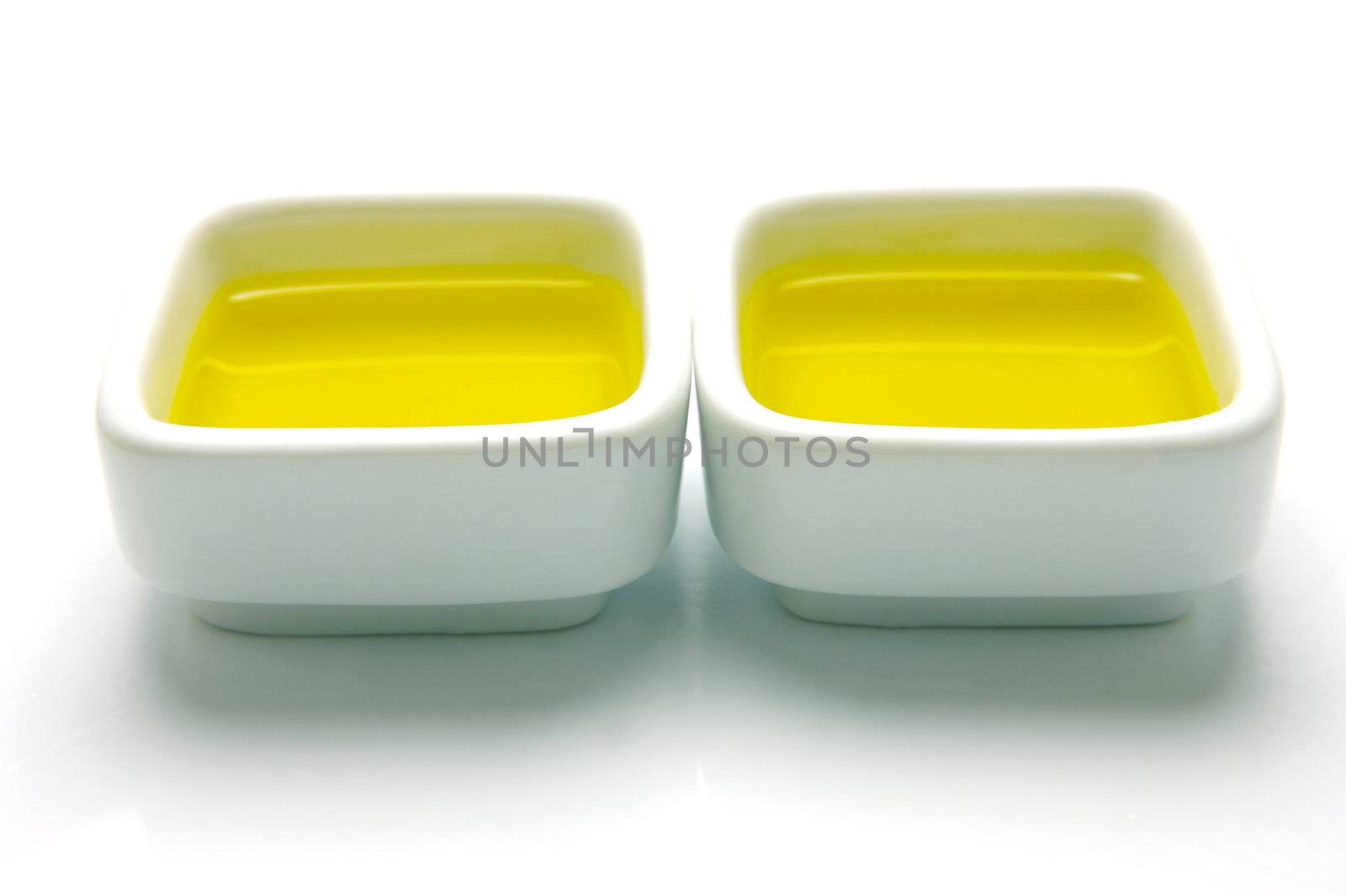 Olive Oil in small serving bowls isolated against a white background