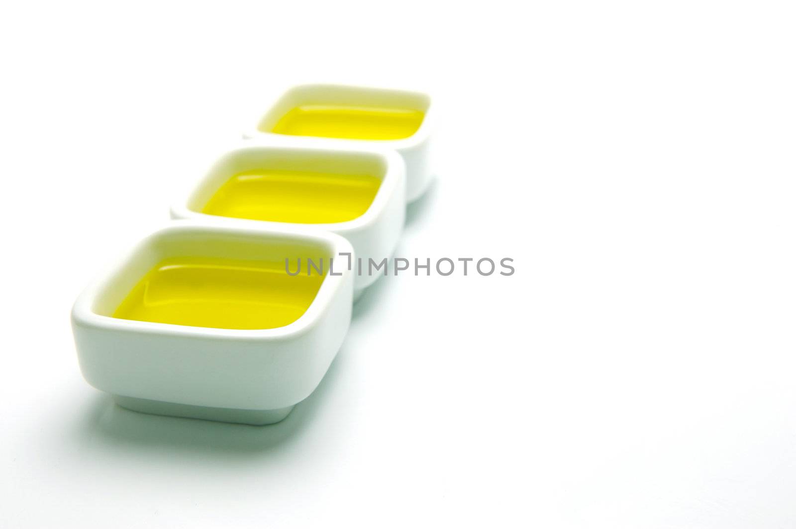 Olive Oil in small serving bowls isolated against a white background