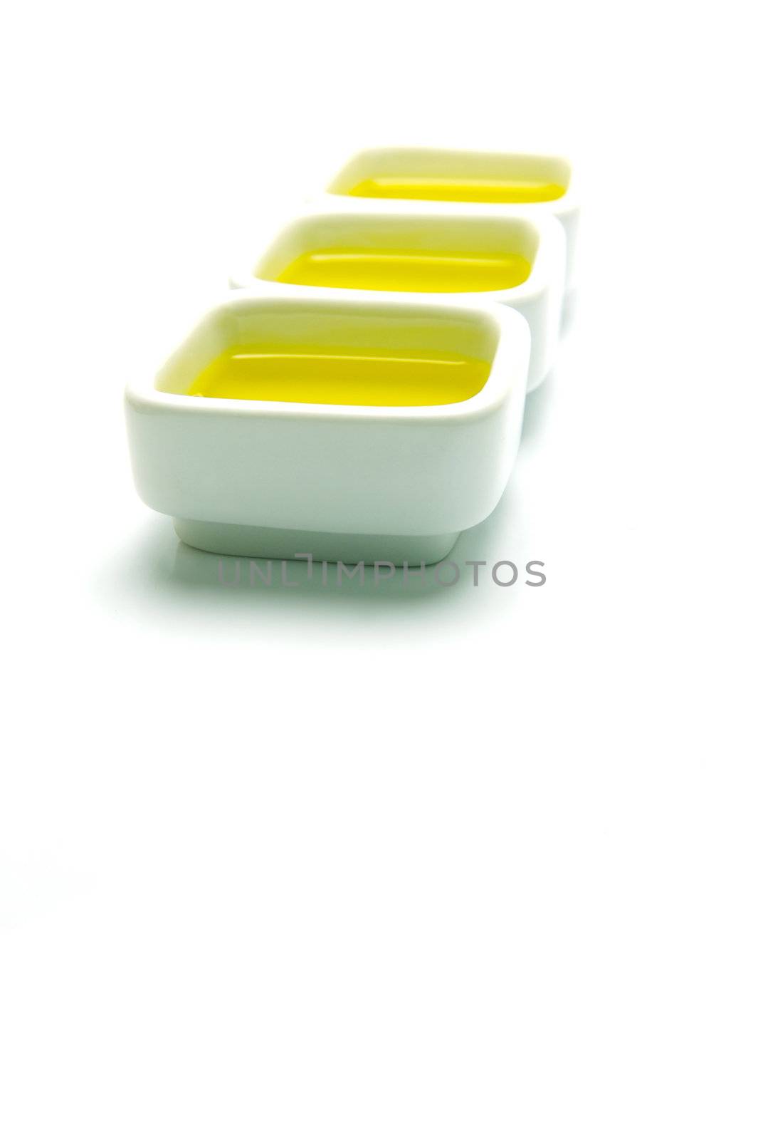 Olive Oil in small serving bowls isolated against a white background
