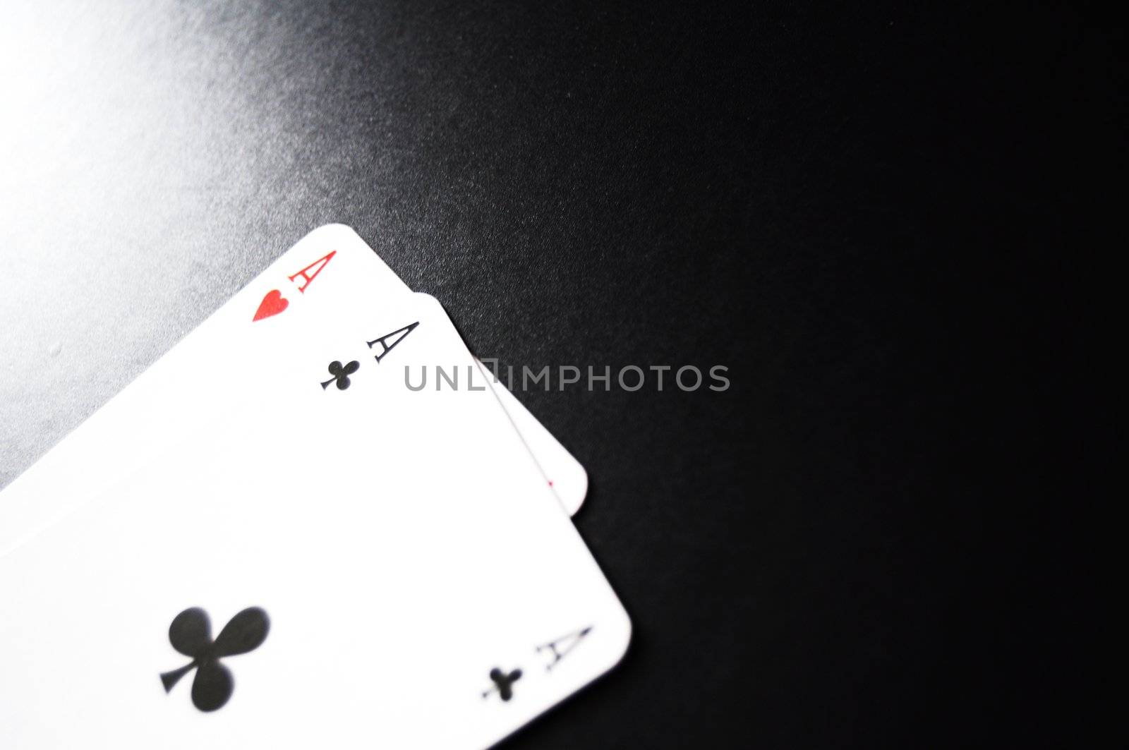 card game with aces on black background
