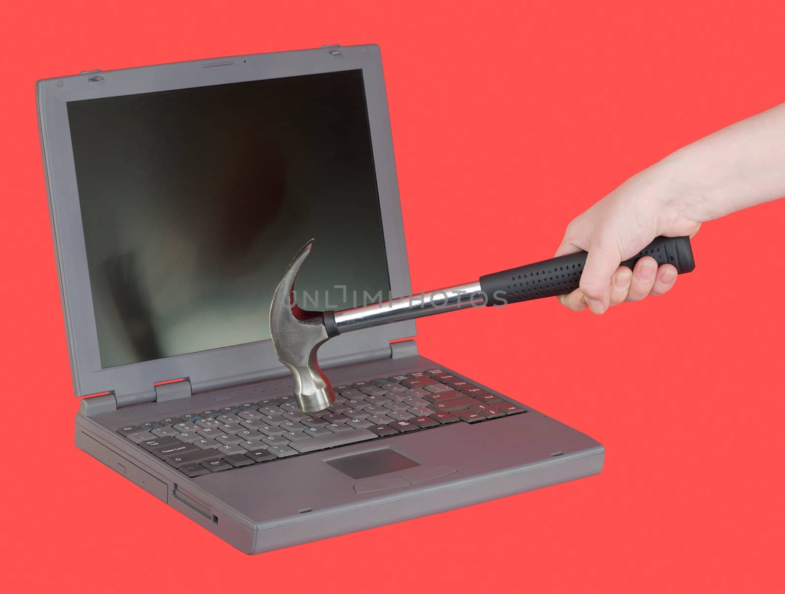 The laptop and hammer on female hand