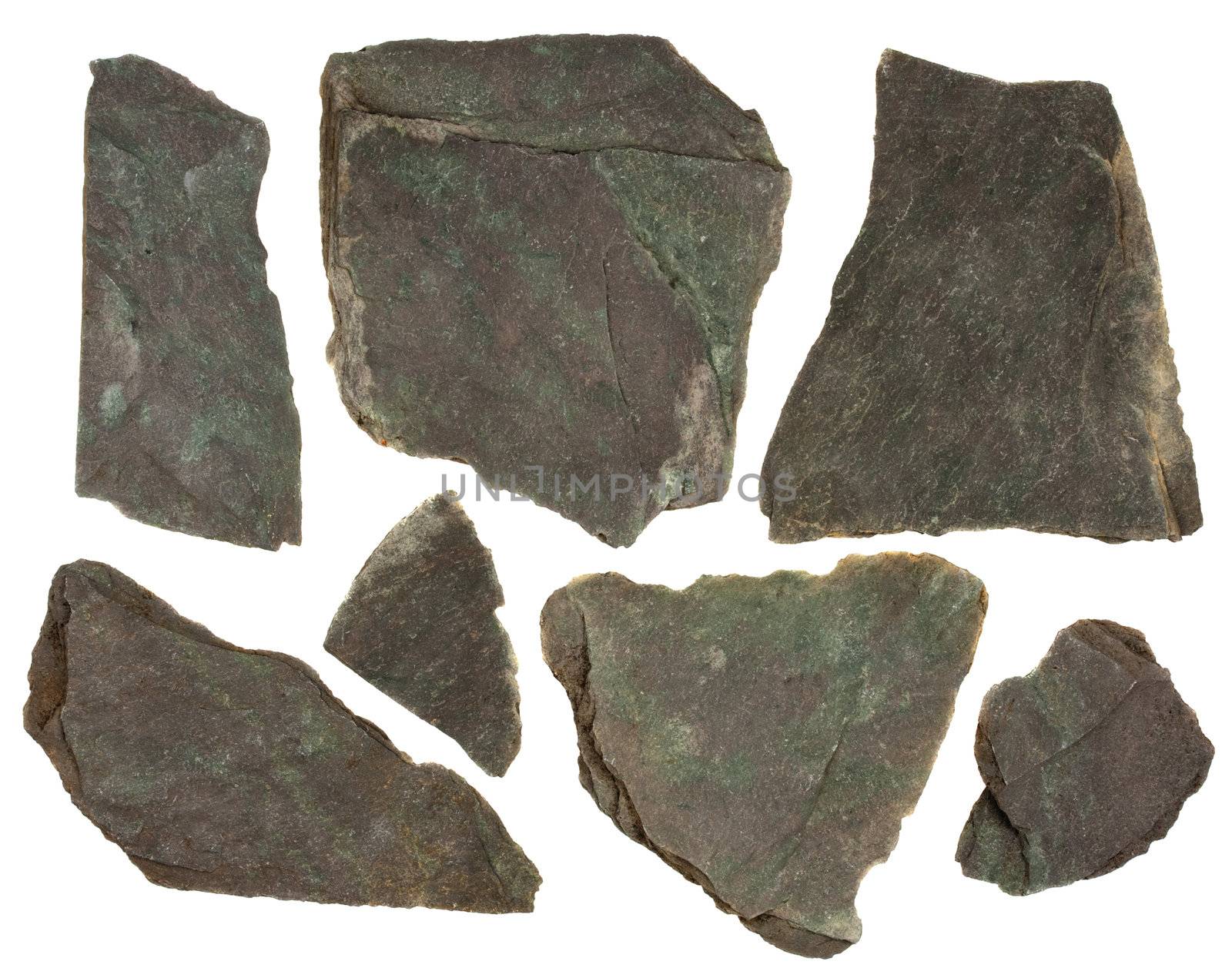 small pieces of flat, gray, fine-grained, foliated slate rock, purple and green tint, sharp edges,  isolated on white