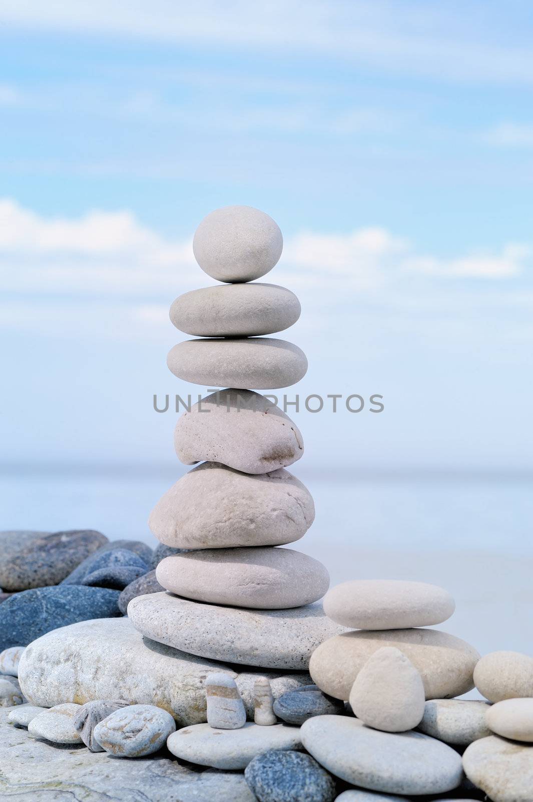 Balancing of white pebbles on the sea coast