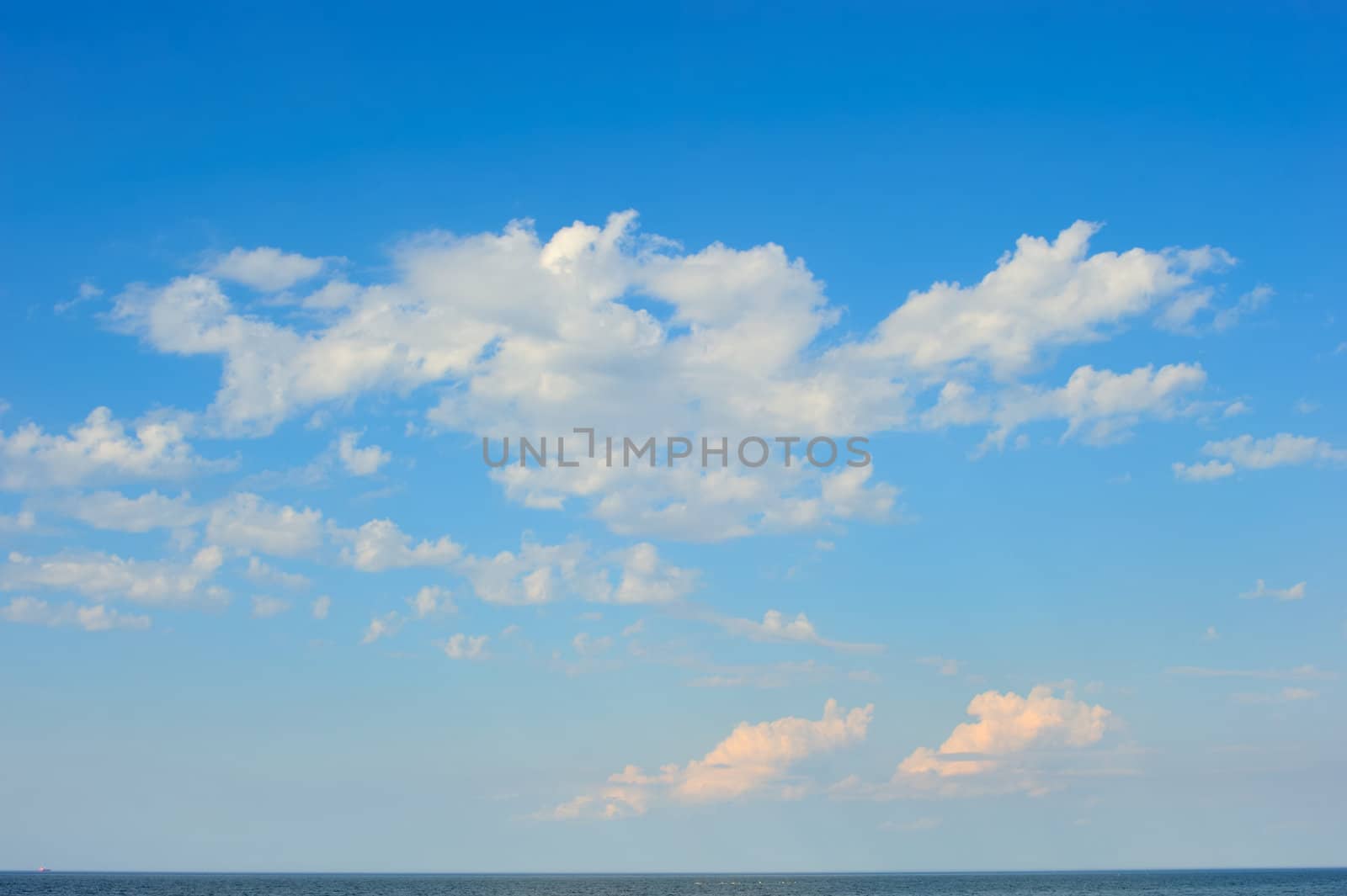 White clouds high above the sea surface