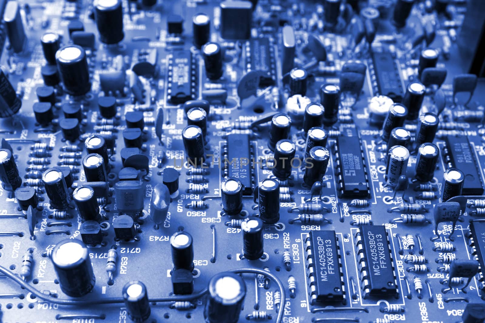 Closeup of electronic parts on mainboard in blue