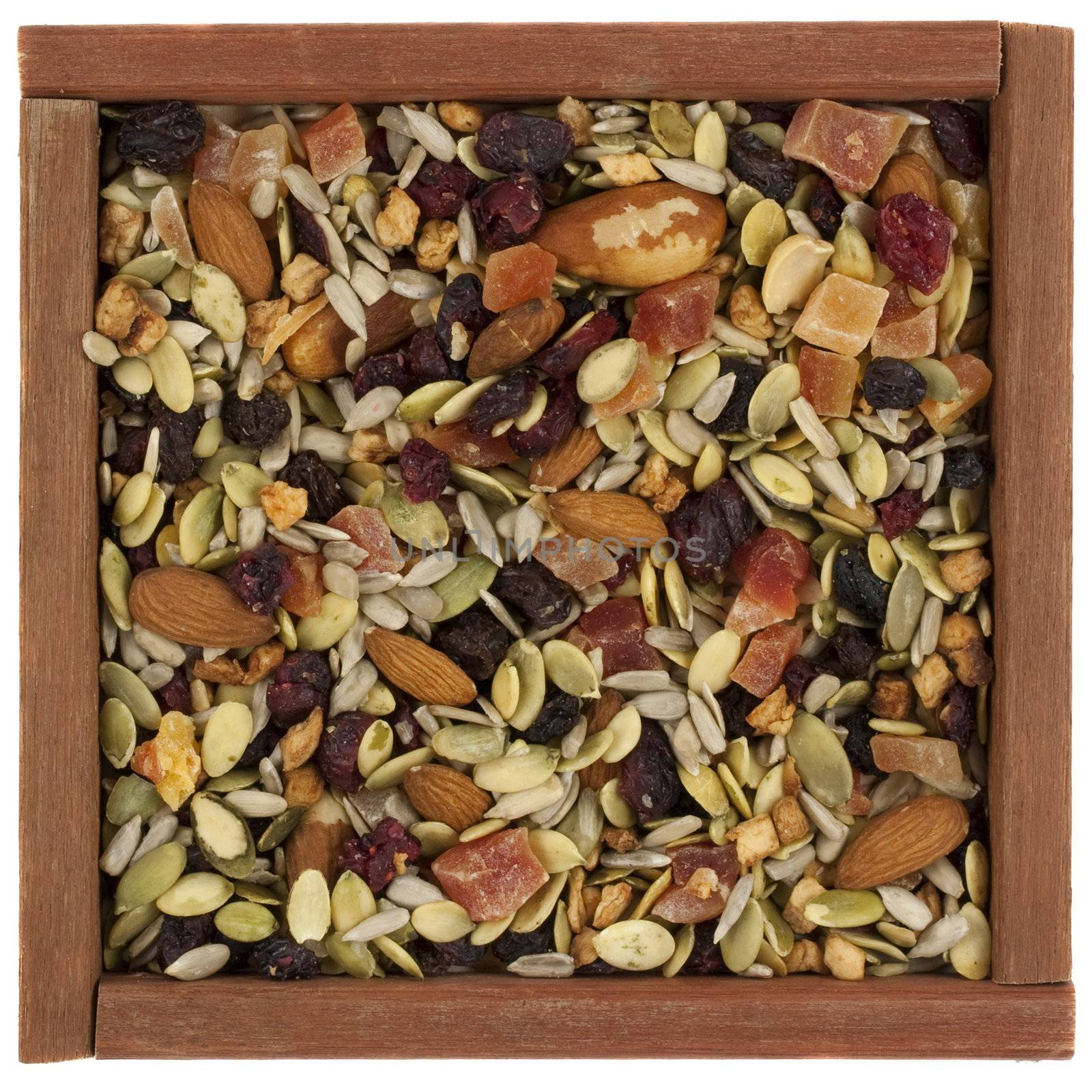 trail mix with nuts, berries and seeds in a wooden box by PixelsAway