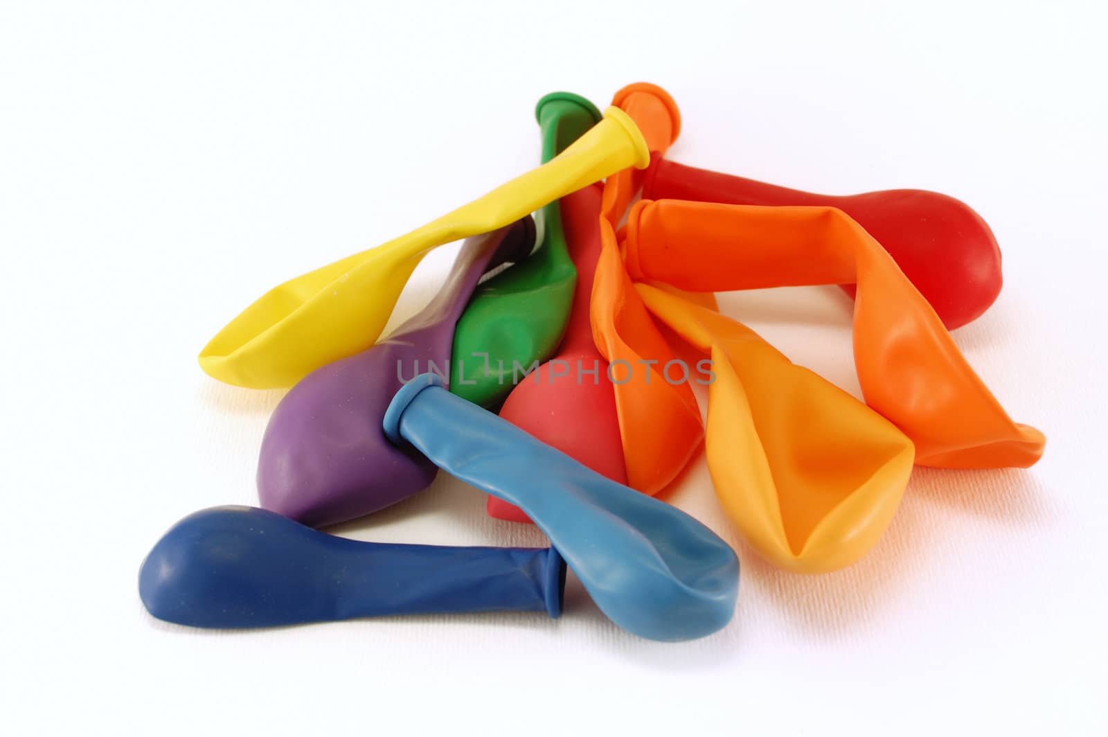 Colourful empty balloons over a white background