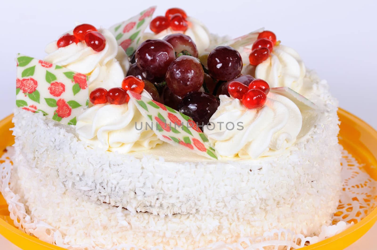 photography of the cake with cream on yellow plate 