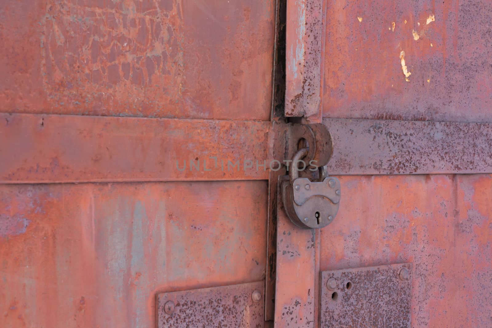 Rusty iron gates locked on old lock