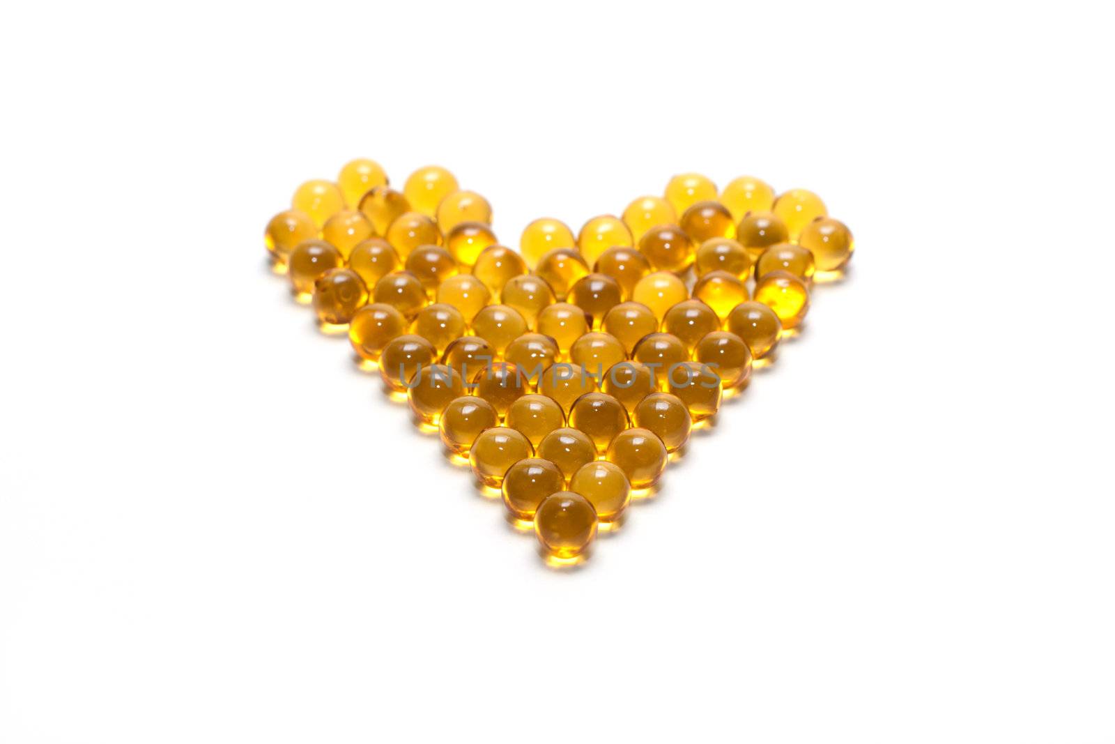 Disposit of the capsules cod-liver oil insulated on white background 