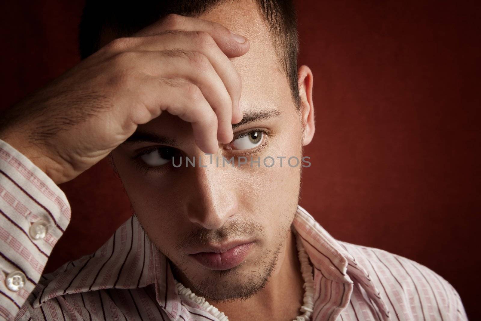 Young man with stubble in serious thought