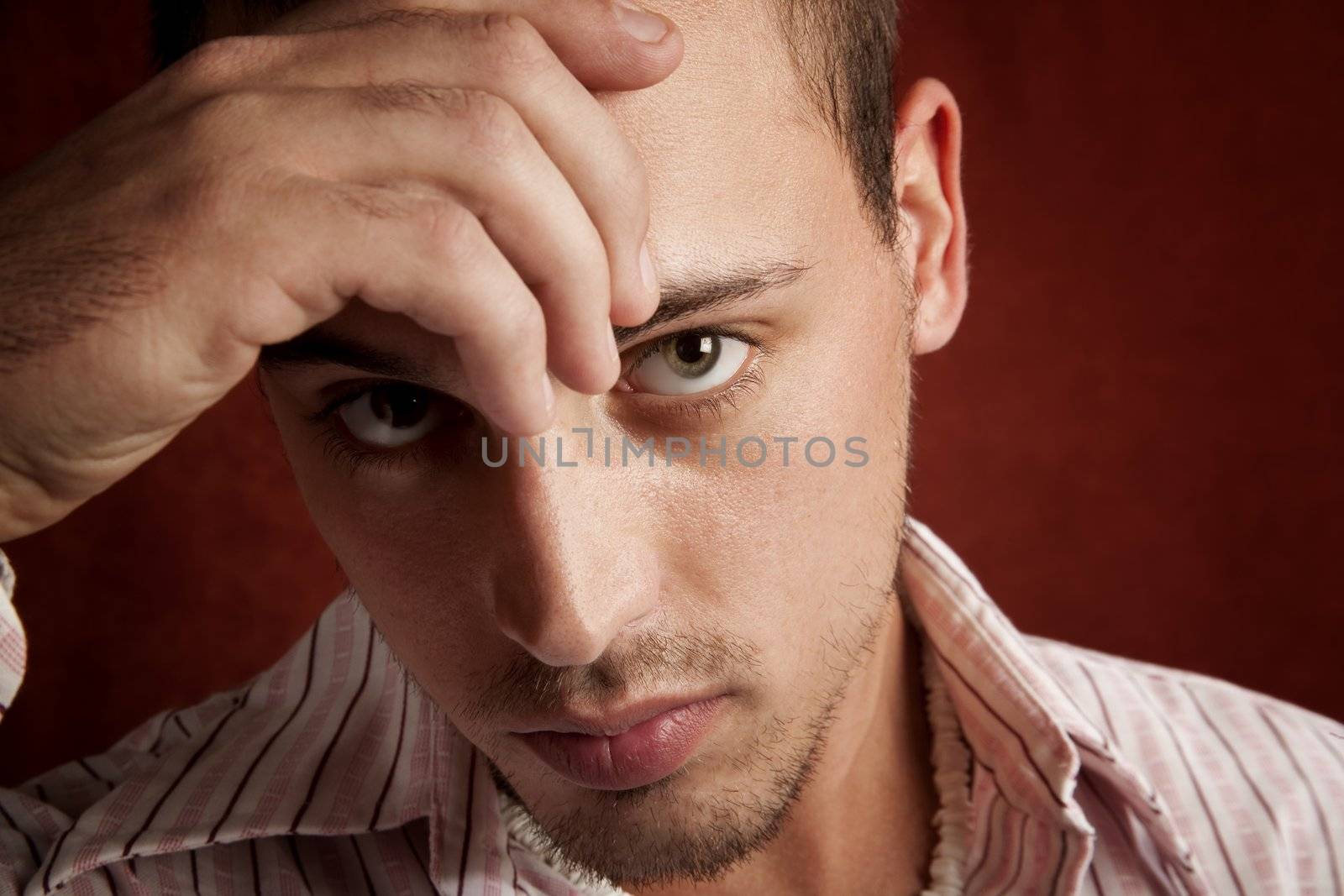 Young man with stubble in serious thought