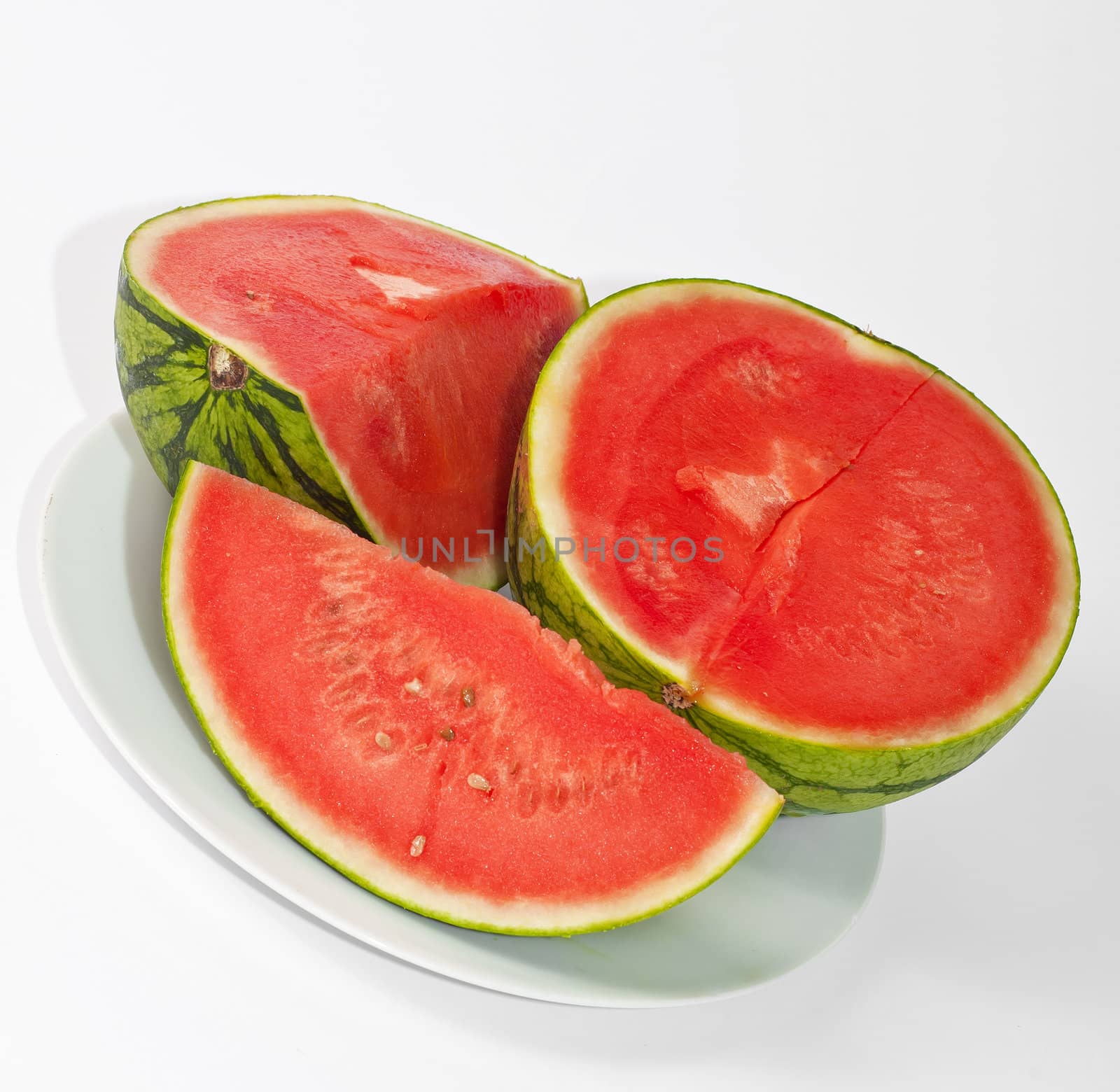 slices of watermelon on a plate and a white background by peus