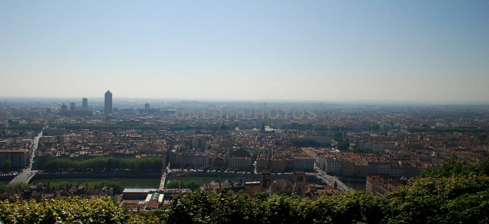 We can see a landscape of Lyon seen from the hill of the basilica fourvi�re, we see the rhone, many buildings and roads.