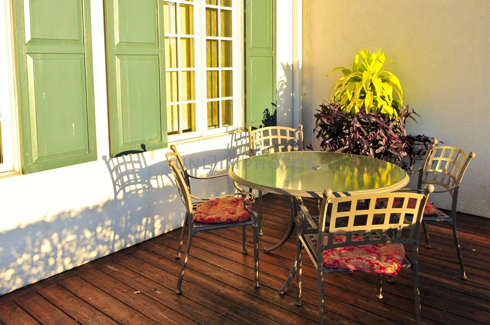 Patio chairs and tables on wooden patio deck