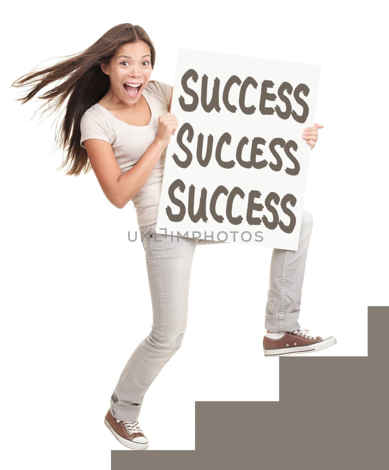 Success sign. Young successful woman showing success sign climbing stairs. Isolated on white background in full length.