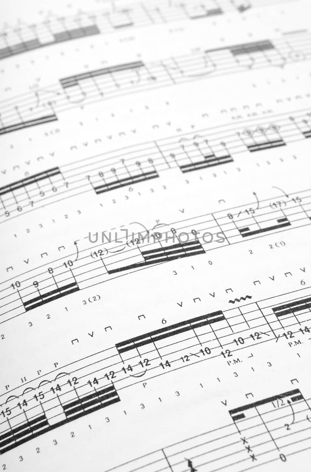 Guitar tabs background. Shallow DOF.