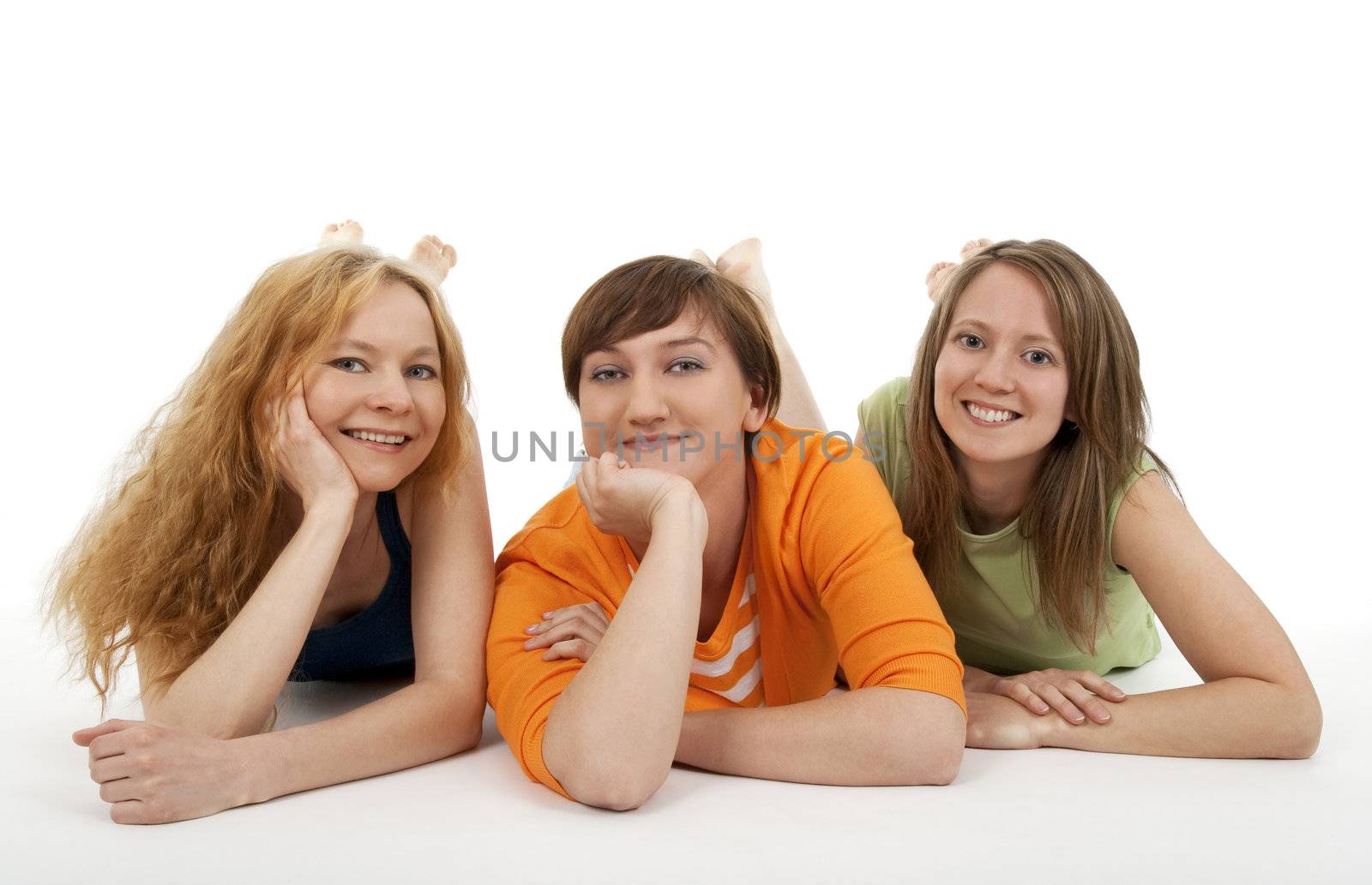 Three smiling friends looking into the camera, relaxing.