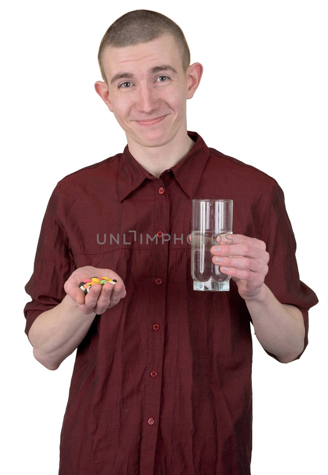 Young man with glass of water and tablets on hands