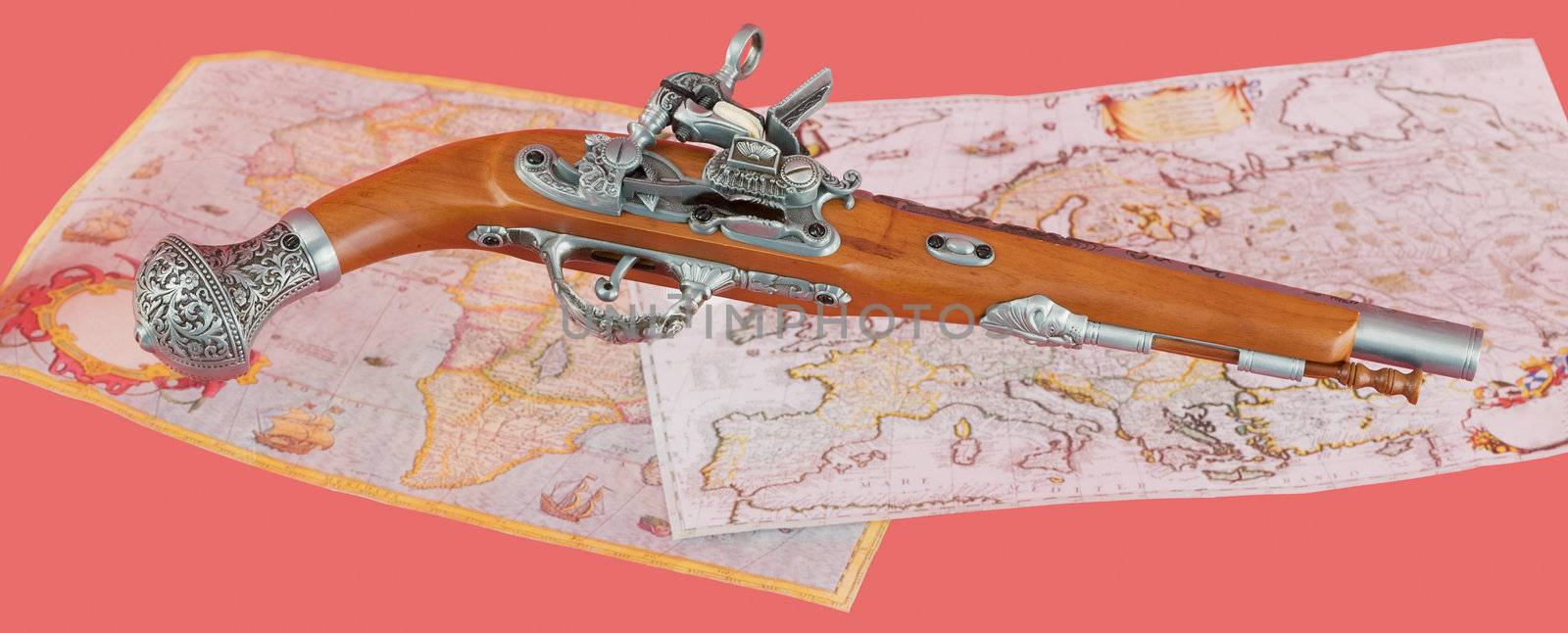 Ancient pistol on antique maps background