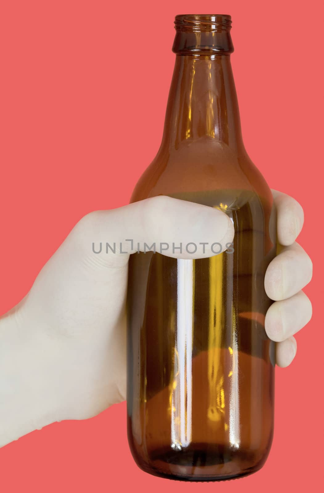 Brown bottle on hand in medical glove
