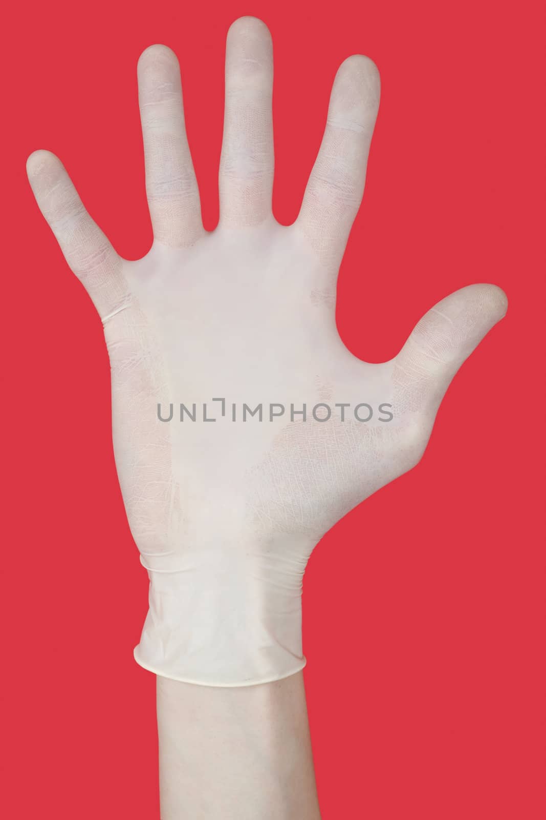 Bristling fingers on medical glove on red background