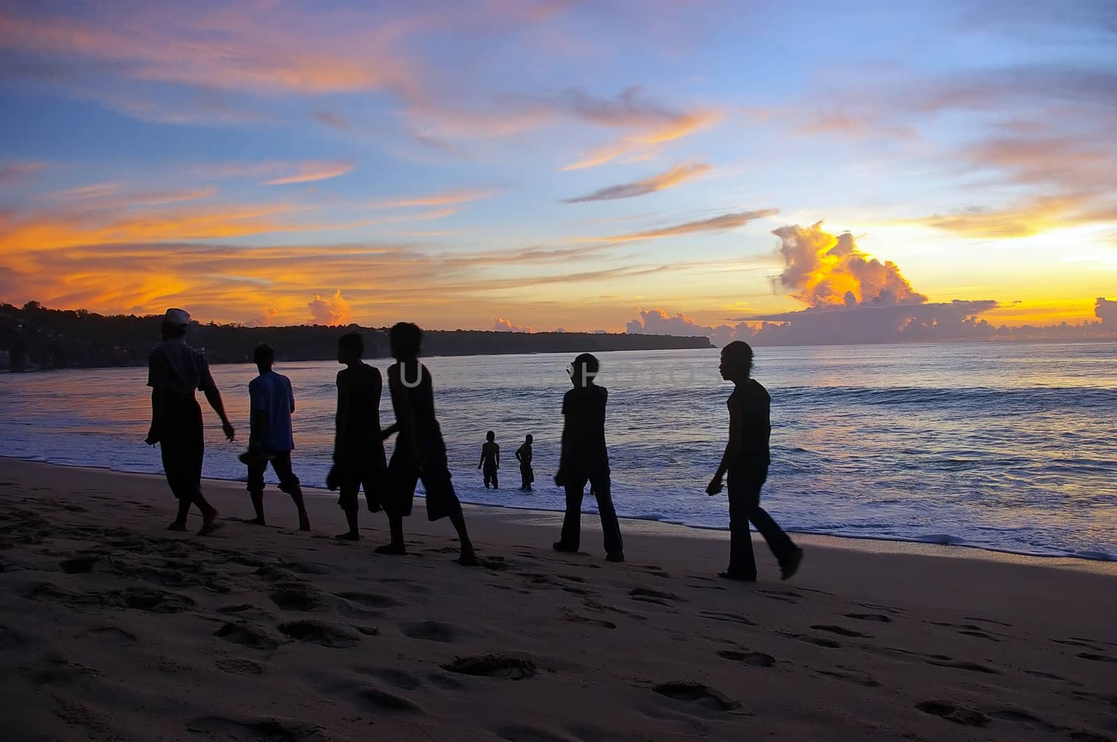 A group of Indonesian day trippers heading home at sunset, Dreamland, Bali, Indonesia.