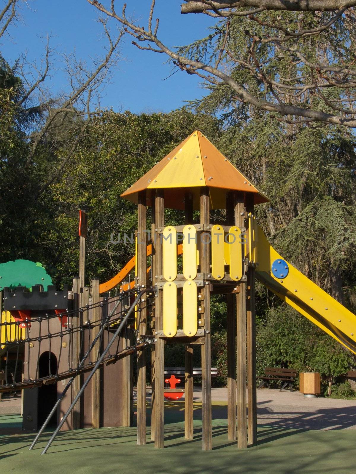 image of a playground area with tower and slide in a park