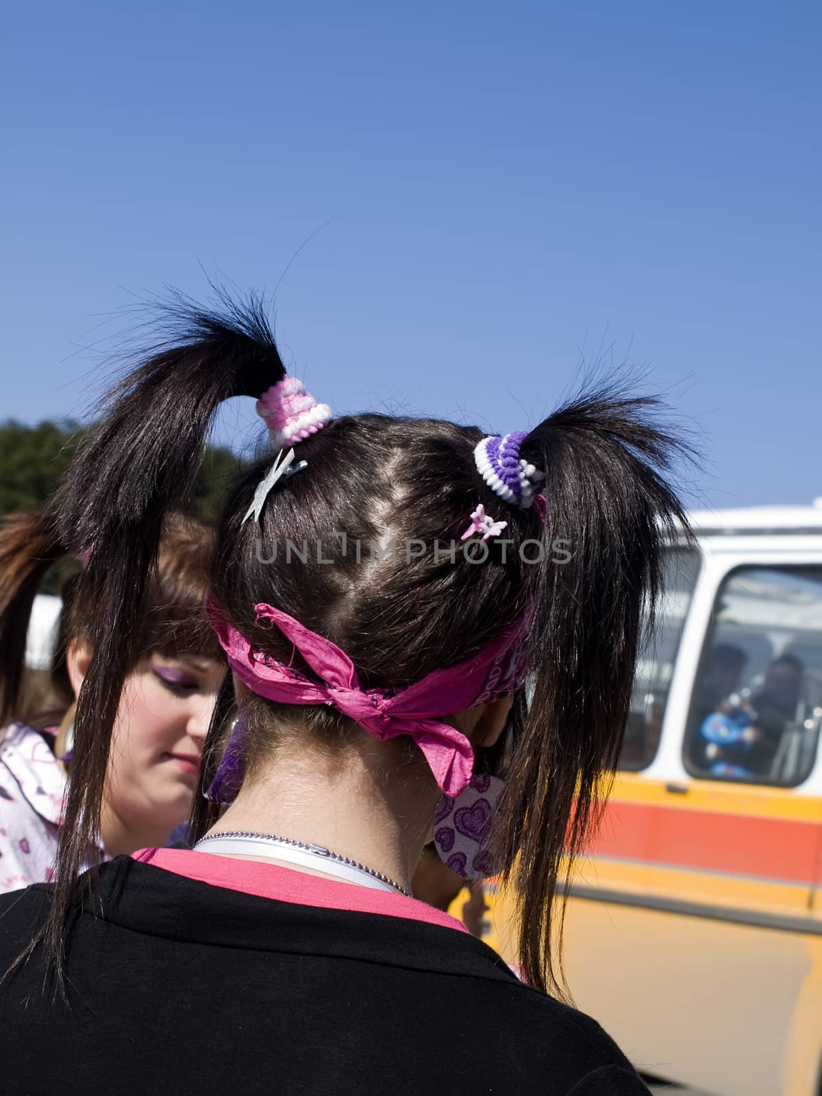 Young pig-tailed teen in a modern grungy hairstyle