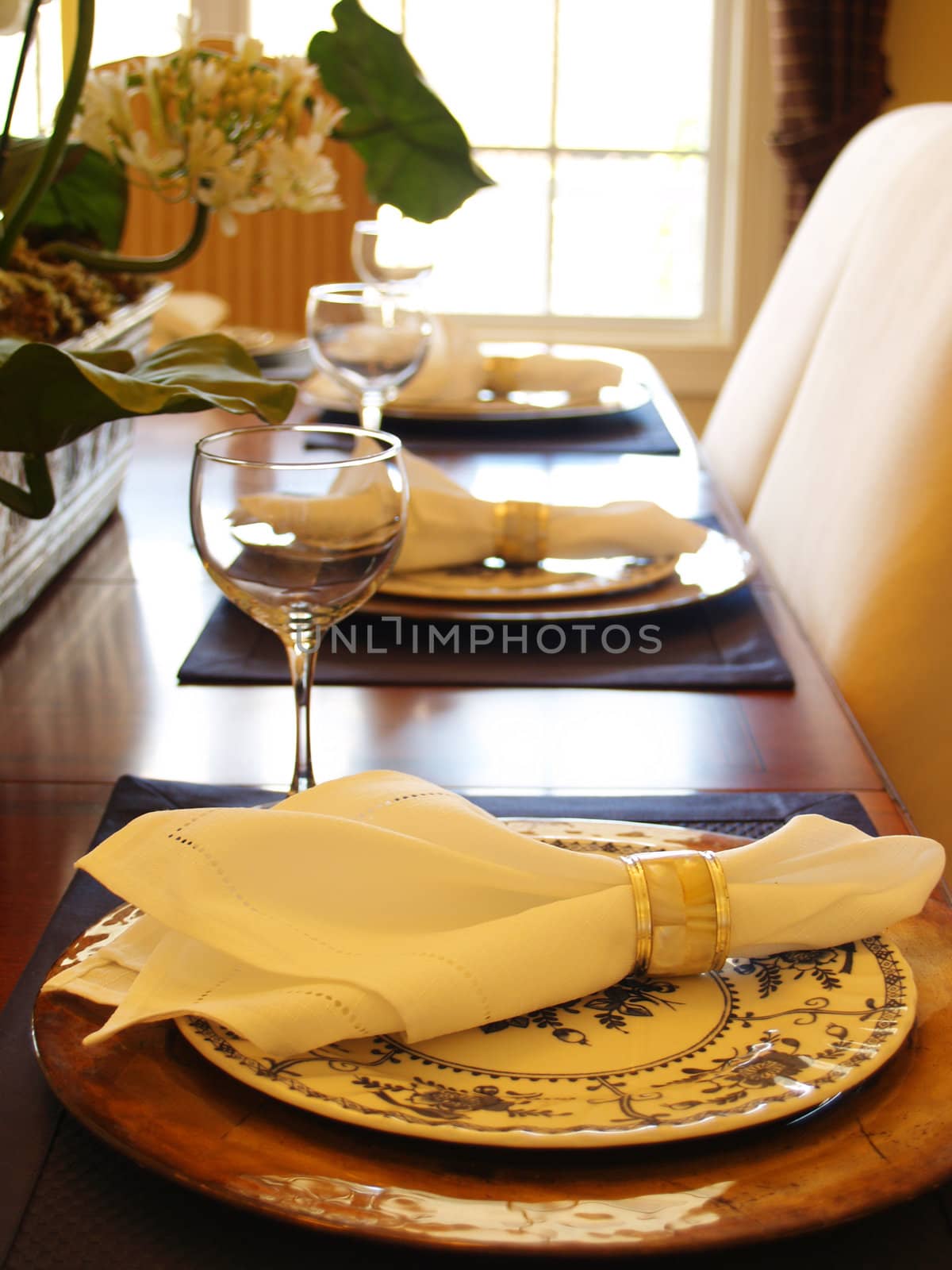 Closeup of three place settings with a bright window in the background