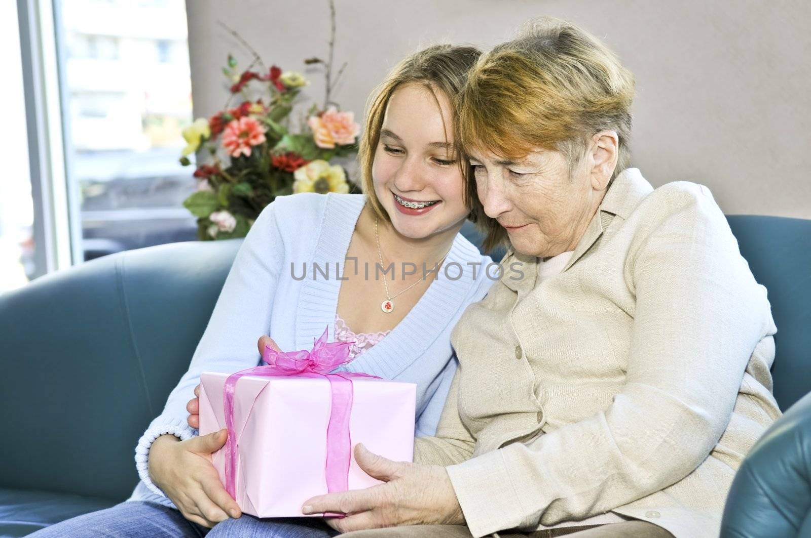 Granddaughter giving a present to her grandmother