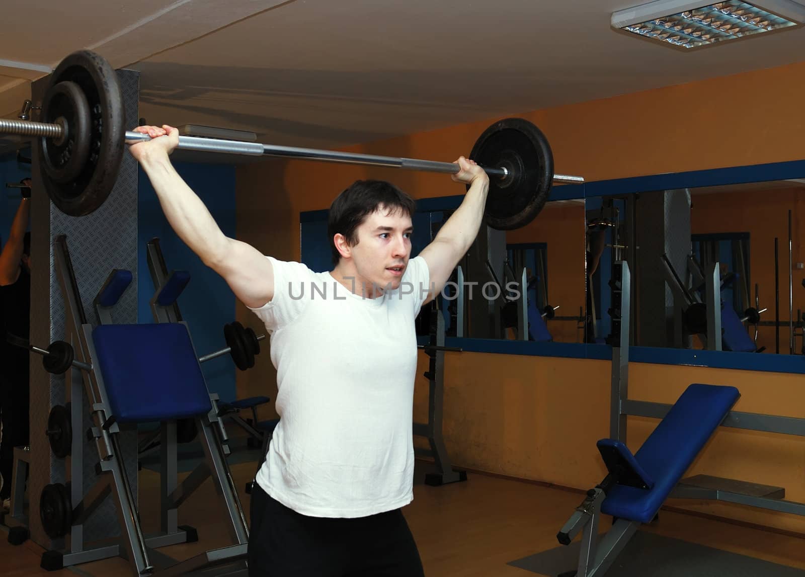 Young bodybuilder in a gym at workout.