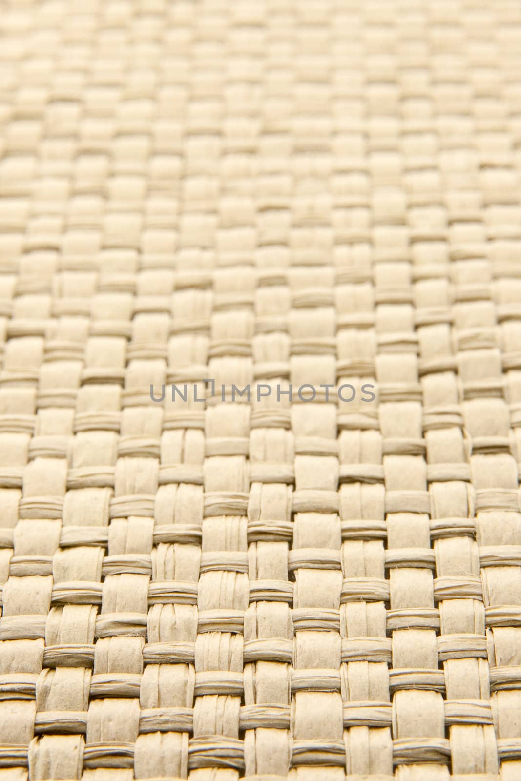 Close up of abstract yellow woven thatch textured background, shallow depth of field