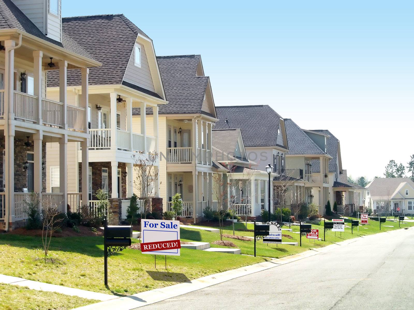 Row of nice homes on a street, all of them for sale