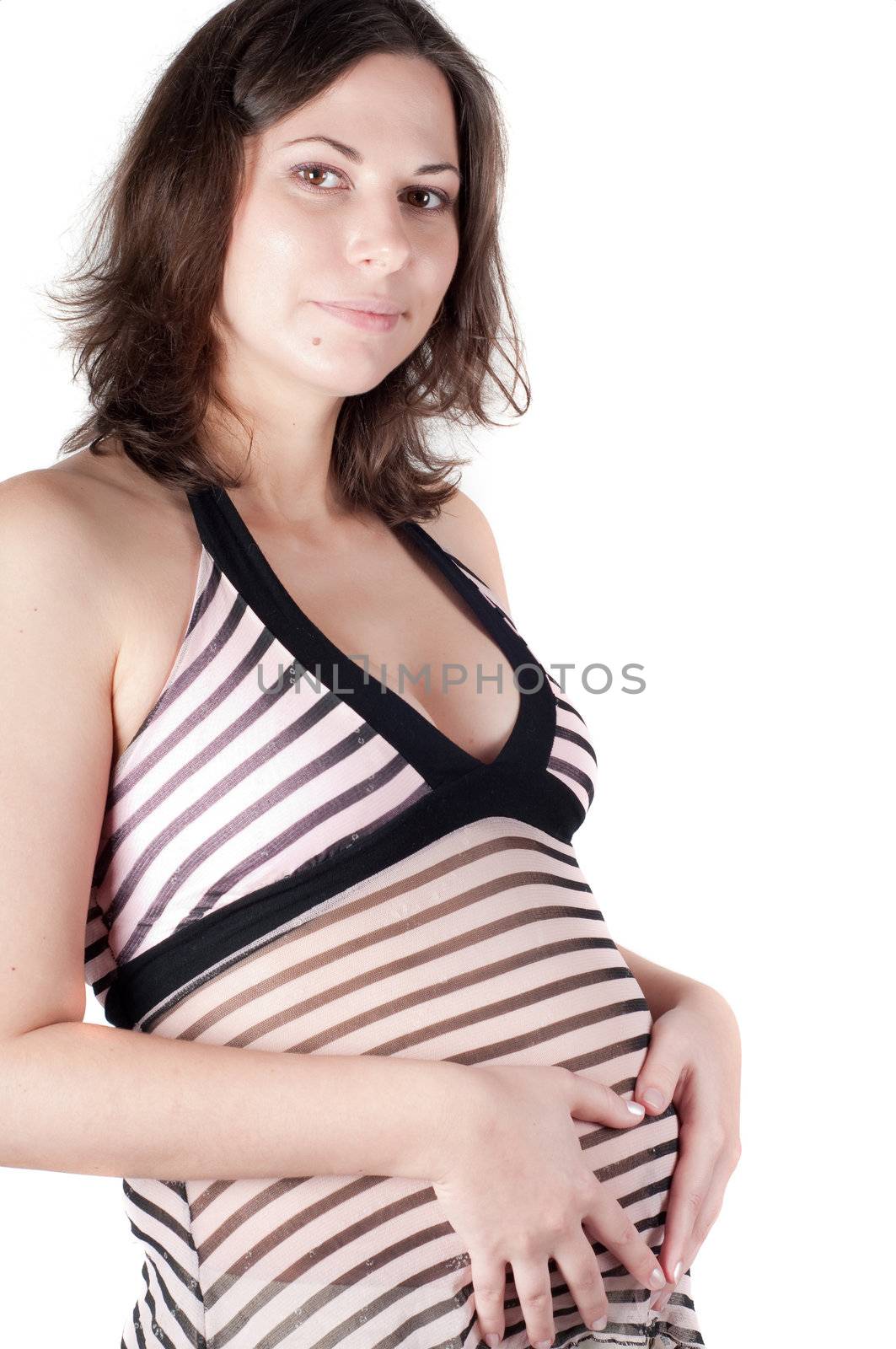 Pregnant woman holding her hands in form of heart sign on her belly