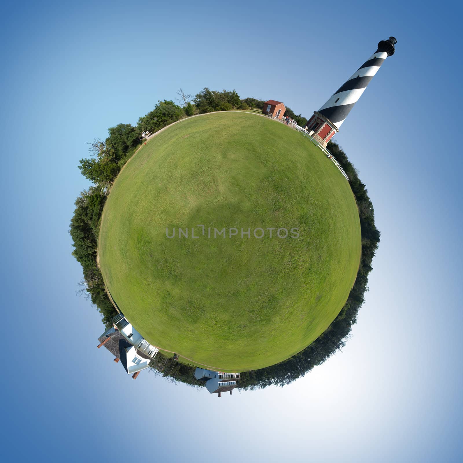 Tiny planet with huge lighthouse and grassy field