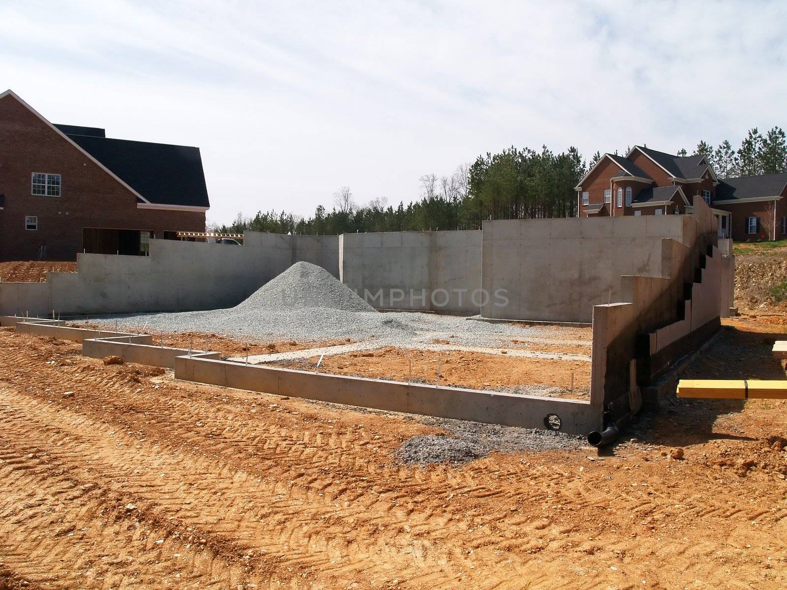 Multilevel concrete house foundation with gravel pile inside