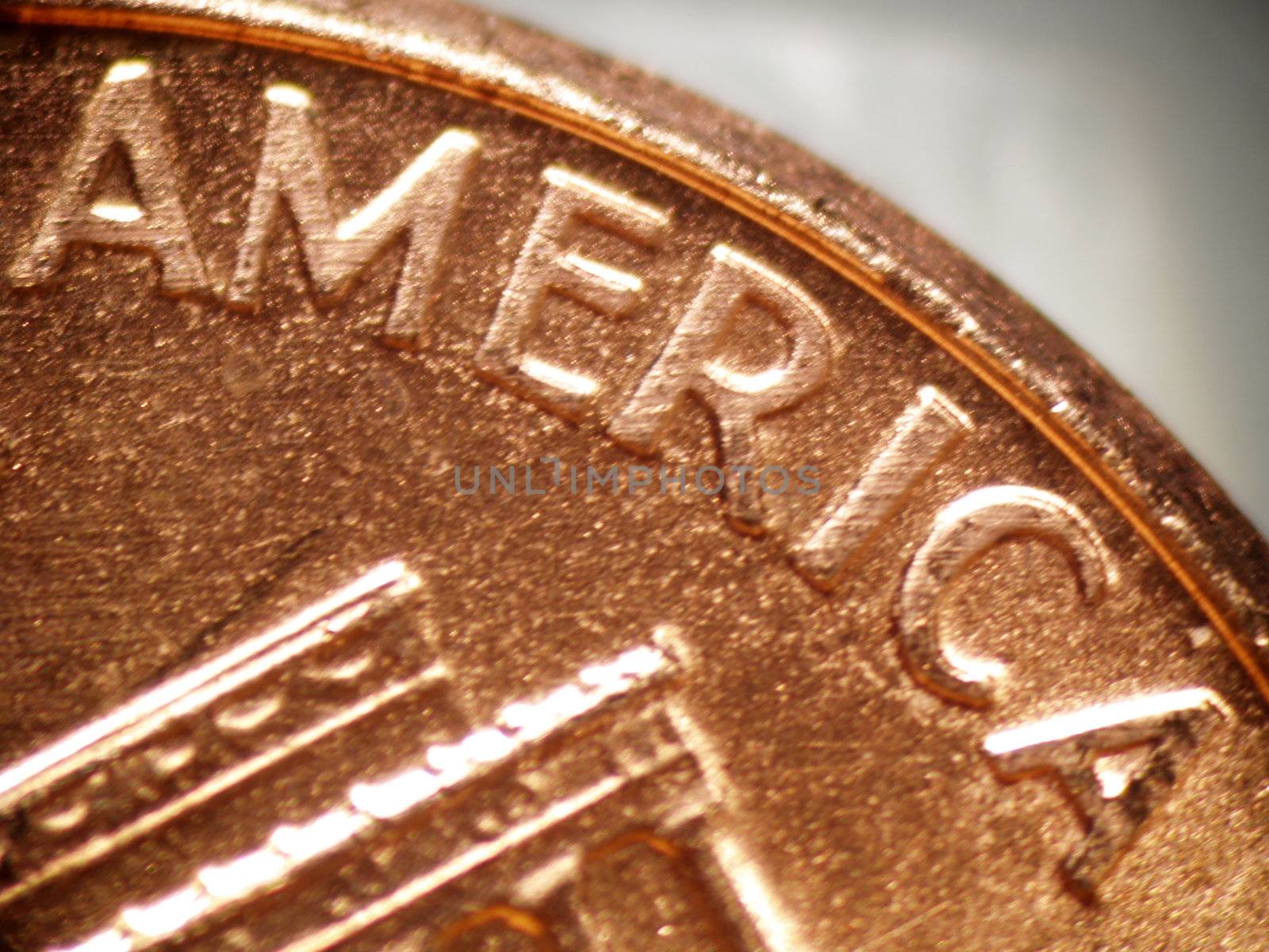 Macro of a penny focused on the word "AMERICA"