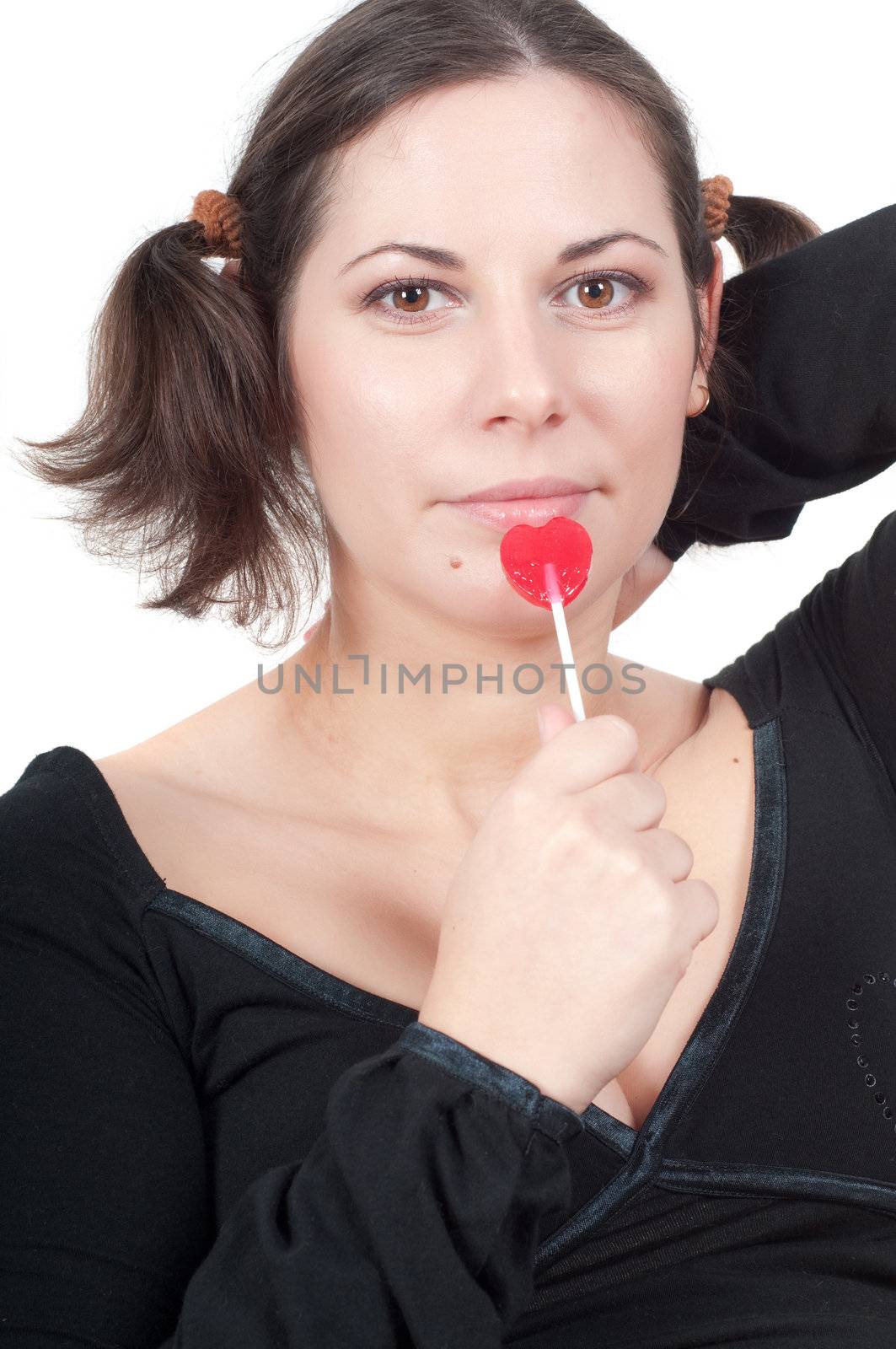 Portrait of pretty woman in black dress eating candy isolated on white