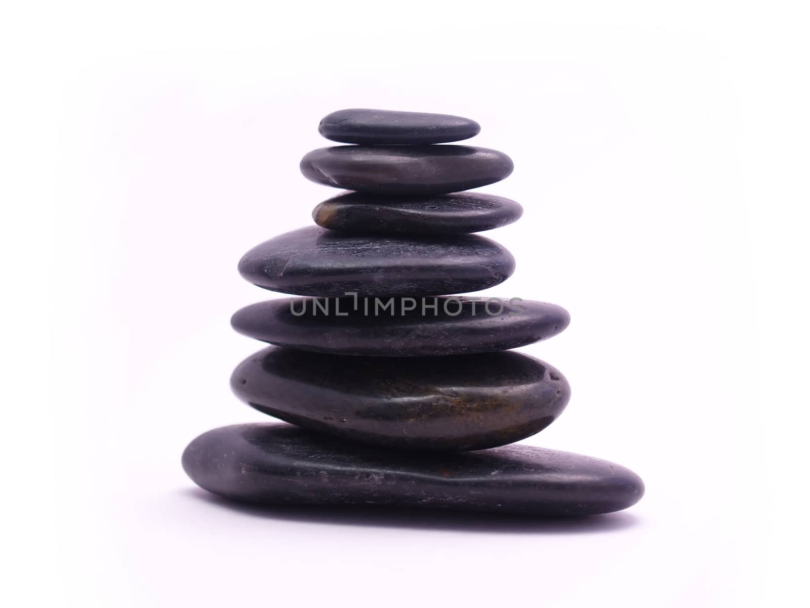 Seven smooth black stones in a stack