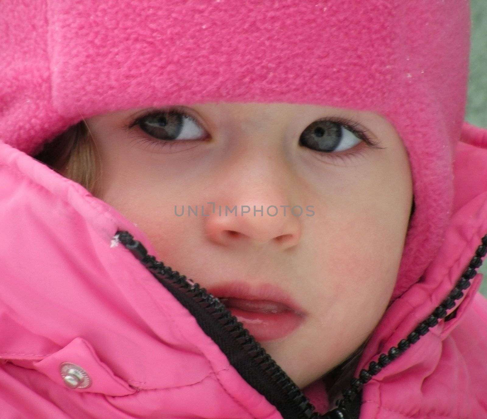 Beautiful children's face in winter with snow            