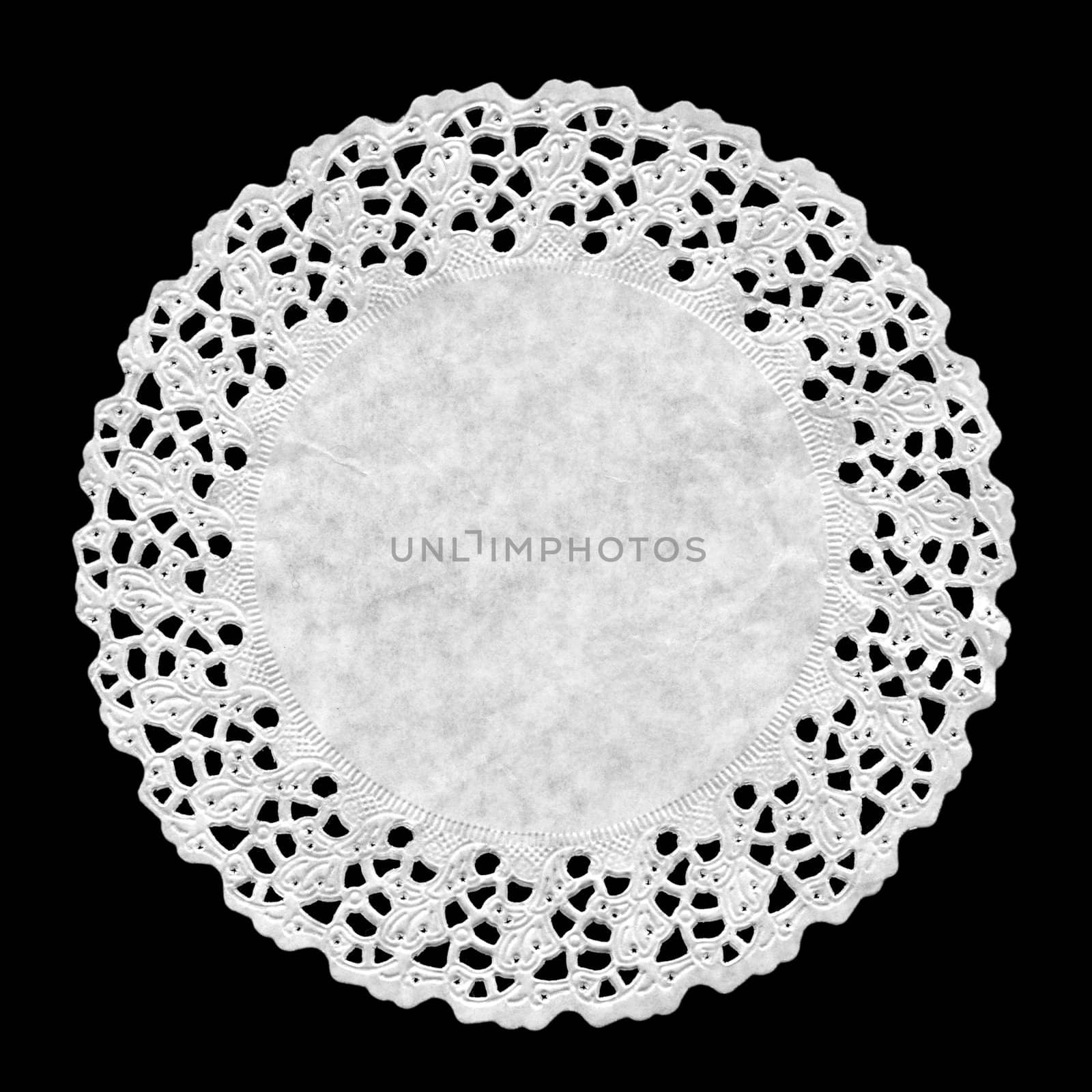 Small circular ornamental doily mat on black background