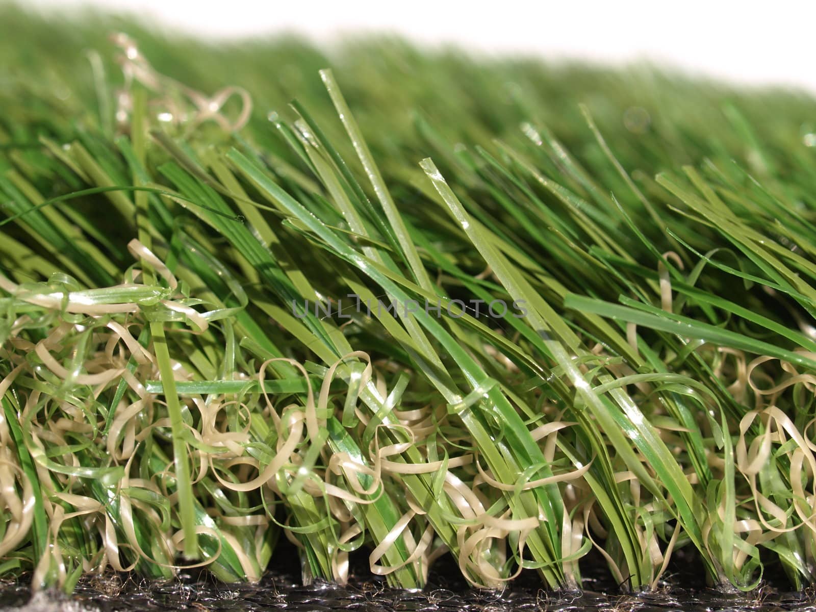 Detail of green grass artificial lawn meadow, useful as a background