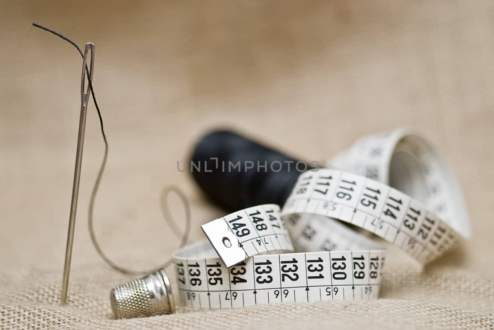 Utensils for sewing on a piece of burlap.